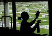 12 March 2007; A cleaner cleans the windows looking out onto the course ahead of the 2007 Cheltenham Racing Festival which takes place from the 13th-16th March. Prestbury Park, Cheltenham, England. Picture credit: David Maher / SPORTSFILE