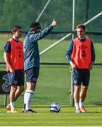 7 October 2014; Republic of Ireland assistant manager Roy Keane, watched on by Robbie Brady and Kevin Doyle, during squad training ahead of their UEFA EURO 2016 Championship Qualifer, Group D, game against Gibraltar on Saturday. Republic of Ireland Squad Training, Gannon Park, Malahide, Co. Dublin. Picture credit: David Maher / SPORTSFILE