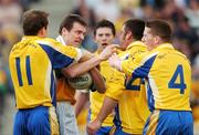 15 April 2007; Offaly's Ciaran McManus reacts to a tackle by Roscommon players, from left, Gary Cox, Brian Mullins, and Robbie Kelly. Allianz National Football League, Division 2A, Offaly v Roscommon, O'Connor Park, Tullamore, Co. Offaly. Picture credit; Brian Lawless / SPORTSFILE