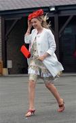 25 April 2007; Deirdre Keane, from Cork, holds onto her hat as she makes her way in for the days racing at the Punchestown National Hunt Festival. Punchestown Racecourse, Co. Kildare. Picture credit: Brian Lawless / SPORTSFILE