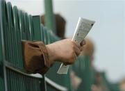 26 April 2007; A racefan holds his racecard during the Swordlestown Cup Novice Steeplechase. Punchestown National Hunt Festival, Punchestown Racecourse, Co. Kildare. Picture credit: Pat Murphy / SPORTSFILE