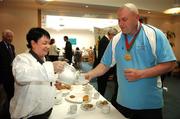 25 April 2007; Special Olympics athlete Joe Nagle, from Mount Argus Basketball Club, has a cup of tea poured for him by Julie Lyons, a chef in Dail Eireann and a volunteer who will be travelling to China with Team Ireland, during the Ceann Comhairle's coffee morning in aid of the Special Olympics Support an Athlete campaign which ends on Friday with the Road to China Collection Day. Visit www.eircom.net/specialolympics for details of collection points or to make an online donation. Houses of the Oireachtas, Leinster House, Dublin. Picture credit: Brendan Moran / SPORTSFILE