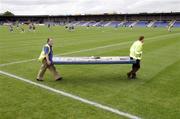 13 May 2007; New season, workmen carry an advertising board into position in advance of the game. Bank of Ireland Leinster Senior Football Championship, Longford v Westmeath, Pearse Park, Longford. Picture credit: Ray McManus / SPORTSFILE