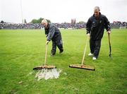 3 June 2007; Groundsmen AIdan Dorothy and Martin Rouset sweep rain water off the pitch. Bank of Ireland Ulster Senior Football Championship, Antrim v Derry, Casement Park, Belfast, Co Antrim. Picture credit: Oliver McVeigh / SPORTSFILE