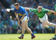 10 June 2007; John Carroll, Tipperary, scores his side's first goal despite the attempted tackle of Mark Foley, Limerick. Guinness Munster Senior Hurling Championship Semi-Final, Limerick v Tipperary, Gaelic Grounds, Limerick. Picture credit: Brendan Moran / SPORTSFILE