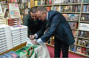 12 November 2014; Former Republic of Ireland international Alan McLoughlin, right, signs the jersey of Eddie O'Mahoney, Kilmacud, Dublin, at the launch of  'A Different Shade of Green. Dubray Bookshop, Grafton Street, Dublin. Picture credit: Barry Cregg / SPORTSFILE