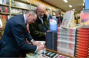 12 November 2014; Former Republic of Ireland international Alan McLoughlin, left, signs the book of Jim Fitzsimons, right, from Blessington, Co. Wicklow, at the launch of  'A Different Shade of Green. Dubray Bookshop, Grafton Street, Dublin. Picture credit: Barry Cregg / SPORTSFILE