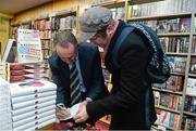 12 November 2014; Former Republic of Ireland international Alan McLoughlin, left, signs the book of Wilton Smith, right, from Cabra, Dublin, at the launch of  'A Different Shade of Green. Dubray Bookshop, Grafton Street, Dublin. Picture credit: Barry Cregg / SPORTSFILE