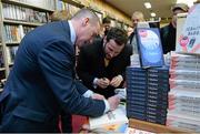 12 November 2014; Former Republic of Ireland international Alan McLoughlin, left, signs the book of Patrick Carroll, right, from Templeogue, Dublin, at the launch of  'A Different Shade of Green. Dubray Bookshop, Grafton Street, Dublin. Picture credit: Barry Cregg / SPORTSFILE