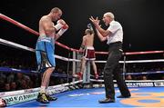 15 November 2014; Referee Micky Vann reaches a ten count on Anthony Fitzgerald during the first round as Gary 'Spike' O'Sullivan celebrates in the background at the end of their middleweight bout. Return of The Mack, 3Arena, Dublin.  Picture credit: Ramsey Cardy / SPORTSFILE