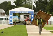 3 July 2007; A worker carries some decking to be laid on the grass in the tented village before the start of the Smurfit Kappa European Open Golf Championship. The K Club, Straffan, Co. Kildare. Picture credit: Brendan Moran / SPORTSFILE