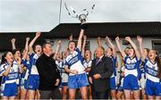 29 November 2014; Castleisland Desmonds captain Lorraine Scanlon lifts the cup, in the company of Ladies Gaelic Football Association president Pat Quill, right, and Paul O'Loughlin, from Tesco Ennis, left. TESCO HomeGrown Intermediate Ladies Football Club Championship Final, Castleisland Desmonds, Kerry v Clonbur, Galway. Corofin, Co. Clare. Picture credit: Diarmuid Greene / SPORTSFILE