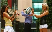 26 July 2007; An official IRFU Rugby ball came in handy to shield the face of a mystery celebrity from photographers anxious to blow the cover of one of Charity Your're A Star's secret contestants. The unnamed contestant has been specially selected by the IRFU Charitable Trust to perform at the 2007 Charity You're A Star which kicks off this Saturday evening. Helping to hide the identity of the mystery singer are models Roberta Rowat, left, and Daniella Moyles. The Beacon Hotel, Beacon Court, Sandyford, Dublin. Picture credit: Brendan Moran / SPORTSFILE