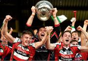 19 October 2014; Ballincollig captain David Lordan lifts the Andy Scannell Cup surrounded by team-mates Dylan Kerstein, left, and Ciaran O'Sullivan, right. Cork County Senior Football Championship Final, Ballincollig v Carbery Rangers, Pairc Ui Chaoimh, Cork. Photo by Sportsfile