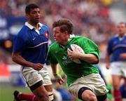 19 March 2000; Brian O'Driscoll of Ireland gets past Emile Ntamack of France on his way to scoring his third try during the Six Nations Rugby Championship match between France and Ireland at the Stade de France in Paris, France. Photo by Ray Lohan/Sportsfile *** Local Caption ***