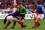 19 March 2000; Brian O'Driscoll of Ireland in action against Stephene Glas and Cedric Desbrosse, right, of France during the Six Nations Rugby Championship match between France and Ireland at the Stade de France in Paris, France. Photo by Matt Browne/Sportsfile