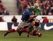 19 March 2000; David Humphreys of Ireland is tackled by Frank Belot of France during the Six Nations Rugby Championship match between France and Ireland at the Stade de France in Paris, France. Photo by Matt Browne/Sportsfile *** Local Caption ***