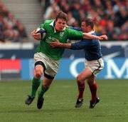 19 March 2000; Brian O'Driscoll of Ireland is tackled by Gerard Merceron of France during the Six Nations Rugby Championship match between France and Ireland at the Stade de France in Paris, France. Photo by Matt Browne/Sportsfile