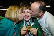 13 October 2007; TEAM Ireland members received a rapturous welcome from family members, friends and supporters when they returned home from the 2007 Special Olympics World Summer Games. TEAM Ireland had an outstanding performance, winning a total of 119 Medals and 69 Ribbons in 11 sports. Pictured are Sharon O'Brien, receiving a kiss from her mother Anne and father Martin, right, from Rockhill Bruree, Co. Limerick. Dublin Airport, Dublin. Picture credit: Matt Browne / SPORTSFILE