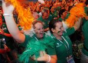 2 October 2007; Team 2007 volunteers Aisling Clarke, left, from Clondalkin, Dublin, and Sarah Doyle, Wicklow, await the arrival of TEAM Ireland into the stadium during the opening ceremony of the 2007 Special Olympics World Summer Games, Shanghai Stadium, Shanghai, China. Picture credit: Ray McManus / SPORTSFILE