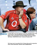 5 August 2007; Two Cork supporters watch the concluding stages of the game. Guinness All-Ireland Hurling Championship Quater-Final Replay, Cork v Waterford, Croke Park, Dublin. Picture by; Stephen McCarthy / SPORTSFILE from 'A Season of Sundays 2007'            This image may be reproduced free of charge when used in conjunction with a review of the book. All other usage ©SPORTSFILE