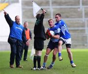 11 November 2007; Michael Walsh, Mayobridge, in action against Ryan McMenamin, Dromore, as the linesman gives a line ball which Dromore manager Noel McGinn agrees with. AIB Ulster Club Football Championship Quarter-Final Replay, Mayobridge v Dromore, Pairc Esler, Newry, Co. Down. Picture credit; Oliver McVeigh / SPORTSFILE