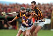 9 April 2000; Chris McGrath of Wexford is tackled by Michael Kavanagh of Kilkenny during the Church & General National Hurling League Division 1B match between Wexford and Kilkenny at O'Kennedy Park in New Ross, Wexford. Photo by Matt Browne/Sportsfile