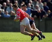 9 April 2000; Ciaran O'Sullivan of Cork is tackled by Senan Connell of Dublin during the Church & General National Football League Division 1A match between Dublin and Cork at Parnell Park in Dublin. Photo by Brendan Moran/Sportsfile