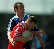 9 April 2000; Donagh Wiseman of Cork is tackled by Ian Robertson of Dublin during the Church & General National Football League Division 1A match between Dublin and Cork at Parnell Park in Dublin. Photo by Brendan Moran/Sportsfile