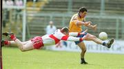 23 April 2000; Francie Grehan of Roscommon is tackled by Niall McOscar of Derry during the Church & General National Football League Division 1 Semi-Final match between Derry and Roscommon at St Tiernach's Park in Clones, Monaghan. Photo by Damien Eagers/Sportsfile