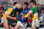 23 April 2000; Gerry Sheridan of Cavan is tackled by Roy Malone, left and Colm Quinn of  Offaly during the Church & General National Football League Division 2 Semi-Final match between Offaly and Cavan at Cusack Park in Mullingar, Westmeath.  Photo by Aoife Rice/Sportsfile