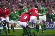 1 April 2000; Anthony Foley of Ireland is tackled by Rupert Moon, left, and Stephen Jones of Wales during the Lloyds TSB 6 Nations match between Ireland and Wales at Lansdowne Road in Dublin. Photo by Brendan Moran/Sportsfile