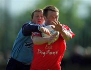 9 April 2000; Michael O'Donovan of Cork is tackled by Paul Croft of Dublin during the Church & General National Football League Division 1A match between Dublin and Cork at Parnell Park in Dublin. Photo by Brendan Moran/Sportsfile