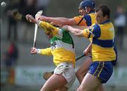 2 April 2000; Paudie Mulhare of Offaly in action against Gerry Quinn and Ollie Baker of Clare during the Church & General National Hurling League Division 1A Round 5 match between Offaly and Clare at St Brendan's Park in Birr, Offaly. Photo by Damien Eagers/Sportsfile