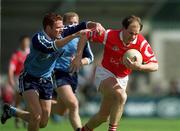9 April 2000; Ronan McCarthy of Cork is tackled by Peadar Andrews of Dublin during the Church & General National Football League Division 1A match between Dublin and Cork at Parnell Park in Dublin. Photo by Aoife Rice/Sportsfile