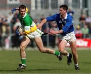 23 April 2000; Roy Malone of Offaly is tackled by Terry Farrelly of Cavan during the Church & General National Football League Division 2 Semi-Final match between Offaly and Cavan at Cusack Park in Mullingar, Westmeath.  Photo by Ray McManus/Sportsfile