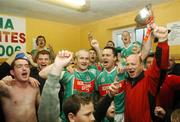 25 November 2007; Ballina Stephenites captain Colm Leonard holding cup celebrates at the end of the game in their dressing room with his team-mate Liam Brady and supporters. AIB Connacht Senior Club Football Championship Final, Ballina Stephenites, Mayo, v St. Brigid's, Roscommon. James Stephen's Park, Ballina, Co. Mayo. Picture credit; David Maher / SPORTSFILE