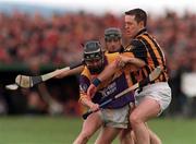 9 April 2000; Chris McGrath of Wexford in action against Michael Kavanagh of Kilkenny during the Church & General National Hurling League Division 1B match between Wexford and Kilkenny at OÕKennedy Park in New Ross, Wexford. Photo by Matt Browne/Sportsfile