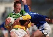 23 April 2000; Pascal Keeaghan of Offaly in action against Conor McCarey of Cavan during the Church & General National Football League Division 2 Semi-Final match between Offaly and Cavan at Cusack Park in Mullingar, Westmeath. Photo by Ray McManus/Sportsfile