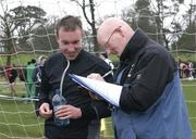 1 March 2008; Winner Cathal Lombard, Leevale A.C, is consulted by Les Martin from the Irish Sports Council Dope Control Unit after the race.The AAI Senior and Junior Inter Club Cross Country Championships. Queens University, Belfast, Co. Antrim. Picture credit: Tomas Greally / SPORTSFILE