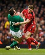 14 March 2015; Cian Healy, Ireland, is tackled by Dan Biggar, Wales. RBS Six Nations Rugby Championship, Wales v Ireland. Millennium Stadium, Cardiff, Wales. Picture credit: Stephen McCarthy / SPORTSFILE