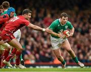 14 March 2015; Robbie Henshaw, Ireland, breaks past the tackle of Mike Phillips, Wales. RBS Six Nations Rugby Championship, Wales v Ireland, Millennium Stadium, Cardiff, Wales. Picture credit: Brendan Moran / SPORTSFILE