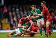 14 March 2015; Sean O'Brien with the support of his Ireland team-mate Tommy Bowe, is tackled by Luke Charteris, left, and Rhys Webb and their Wales team-mate George North, right. RBS Six Nations Rugby Championship, Wales v Ireland. Millennium Stadium, Cardiff, Wales. Picture credit: Stephen McCarthy / SPORTSFILE