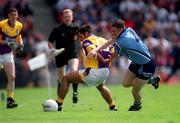 11 June 2000; Scott Doran of Wexford in action against Coman Giggins of Dublin during the Bank of Ireland Leinster Senior Football Championship Quarter-Final match between Dublin and Wexford at Croke Park in Dublin. Photo by Brendan Moran/Sportsfile