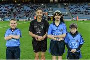 28 March 2015; Mascots Daniel Sheridan, Scoil Mhuire, Howth, Clodagh McCahey, Gael Scoil Chnoc Lamhna, Knocklyon, and Sean McCabe, Gael Scoil Míde, Kilbarrack, with young referee Jasmin Kamtoh, Holy Trinity, NS, second left, before the game. Allianz Football League, Division 1, Round 6, Dublin v Derry. Croke Park, Dublin. Picture credit: Ray McManus / SPORTSFILE