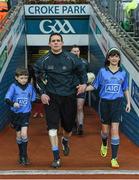 28 March 2015; Dublin captain Stephen Cluxton and mascots Sean McCabe, Gael Scoil Míde, Kilbarrack, and Clodagh McCahey, Gael Scoil Chnoc Lamhina, Knocklyon, run out before the game. Allianz Football League, Division 1, Round 6, Dublin v Derry. Croke Park, Dublin. Picture credit: Ray McManus / SPORTSFILE