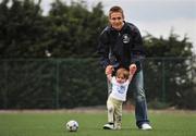 9 April 2008; At the launch of the 2008 Danone Nations Cup is Ireland's &quot;Godfather&quot; Kevin Doyle with one year old Seren Evans. The Danone Nations Cup is the world's top football tournament for children aged 10-12. This years World Finals will see over 600 players from the 40 participating countries come together in Parc De Prince, Paris from the 5-7th September. The event is based on four fundamental values: openness, pleasure of the game, fair-play and accessibility. This years World finals take place in Parc De Prince Paris in September. Ireland's National Final takes place in June. Oscar Traynor Complex, Oscar Traynor Road, Coolock, Dublin. Picture credit: Brian Lawless / SPORTSFILE