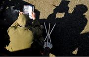 6 April 2015; A racegoer studies his race program while enjoying a cigar. Fairyhouse Easter Festival, Fairyhouse, Co. Meath. Picture credit: Cody Glenn / SPORTSFILE