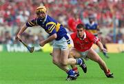 2 July 2000; Eamonn Corcoran of Tipperary in action against Derek Barrett of Cork during the Guinness Munster Senior Hurling Championship Final between Cork and Tipperary at Semple Stadium in Thurles, Tipperary. Photo by Ray McManus/Sportsfile