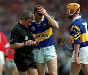 2 July 2000; Referee Pat Horan takes the name of Michael Ryan of Tipperary during the Guinness Munster Senior Hurling Championship Final between Cork and Tipperary at Semple Stadium in Thurles, Tipperary. Photo by Ray McManus/Sportsfile